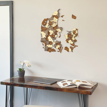 Denmark wooden wall map close view above a resin-topped desk