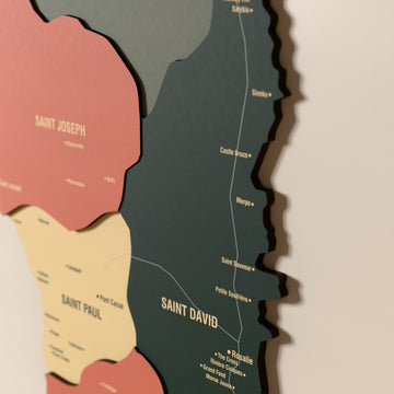 Close-up of the Sage Dominica wooden wall map with layered regions and printed names