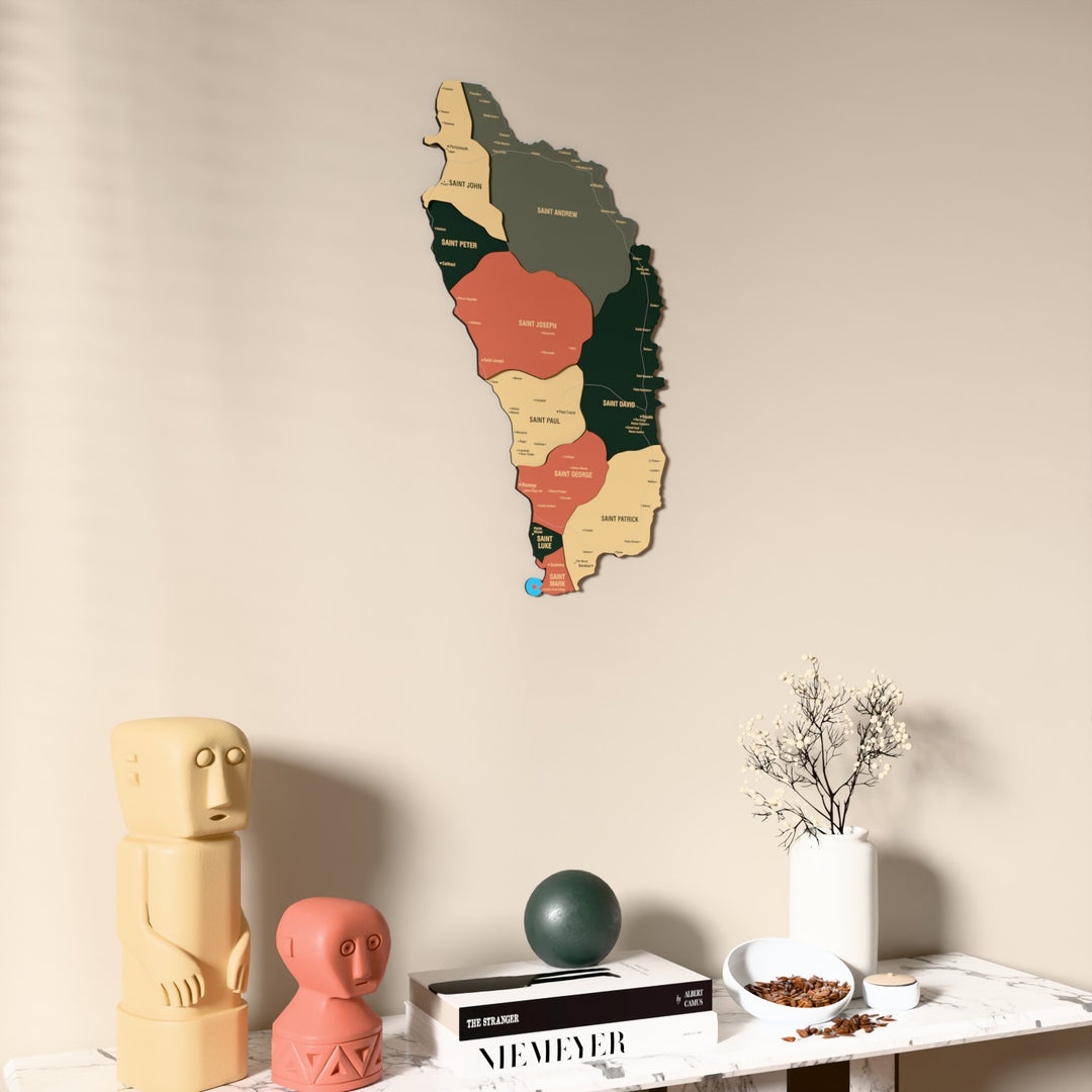 Sage Dominica wooden wall map on a beige wall above a console with figurines