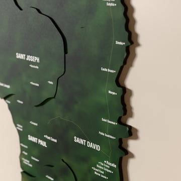 Close-up of the Satellite Dominica wooden wall map with layered regions and printed names