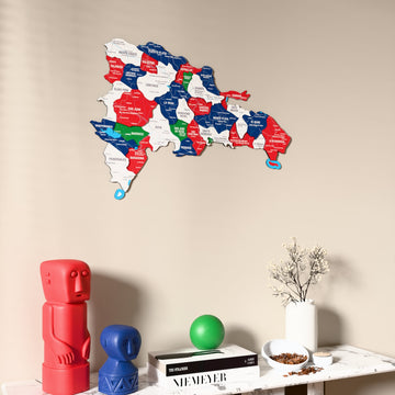 Flag colored Dominican Republic wooden wall map on a beige wall above a console with figurines