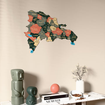 Sage Dominican Republic wooden wall map on a beige wall above a console with figurines