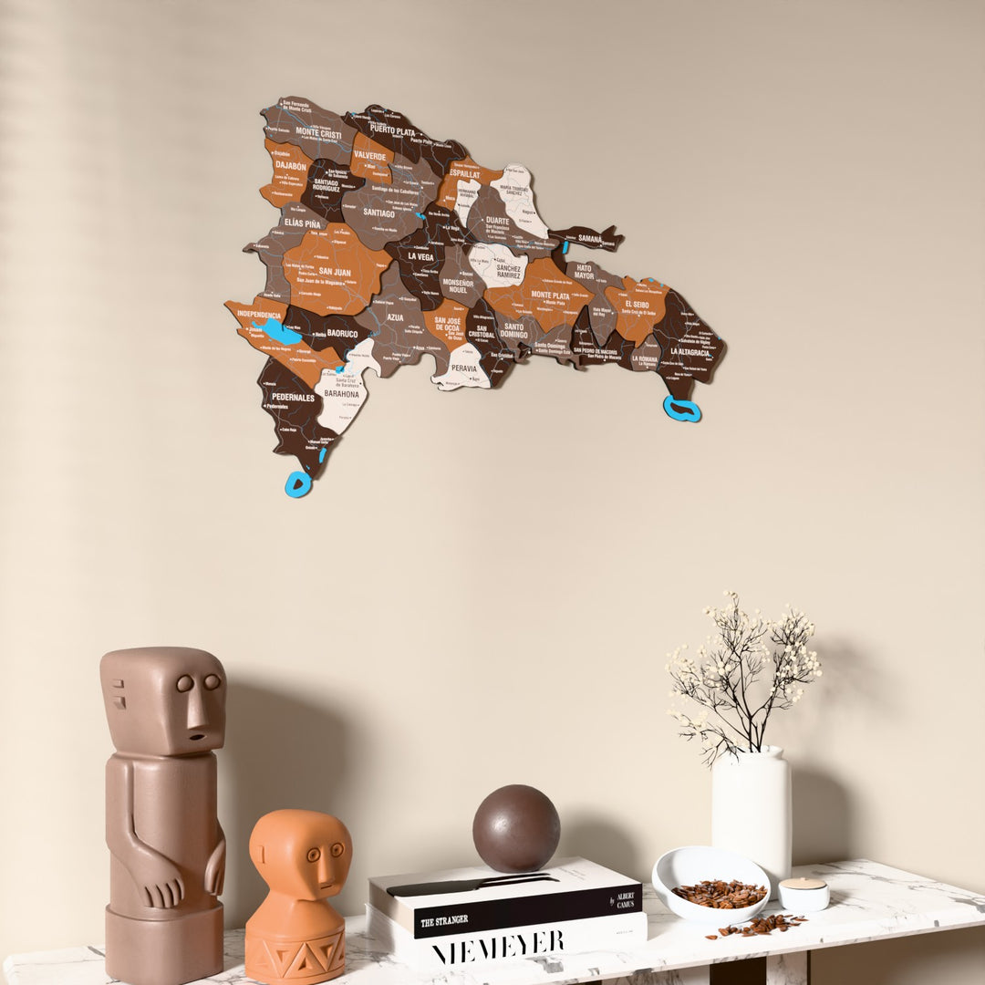 Soil Dominican Republic wooden wall map on a beige wall above a console with figurines