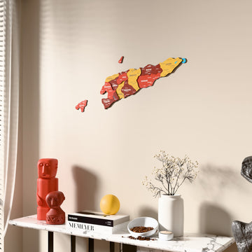 Flag colored East Timor wooden wall map beside a sheer curtain, angled view
