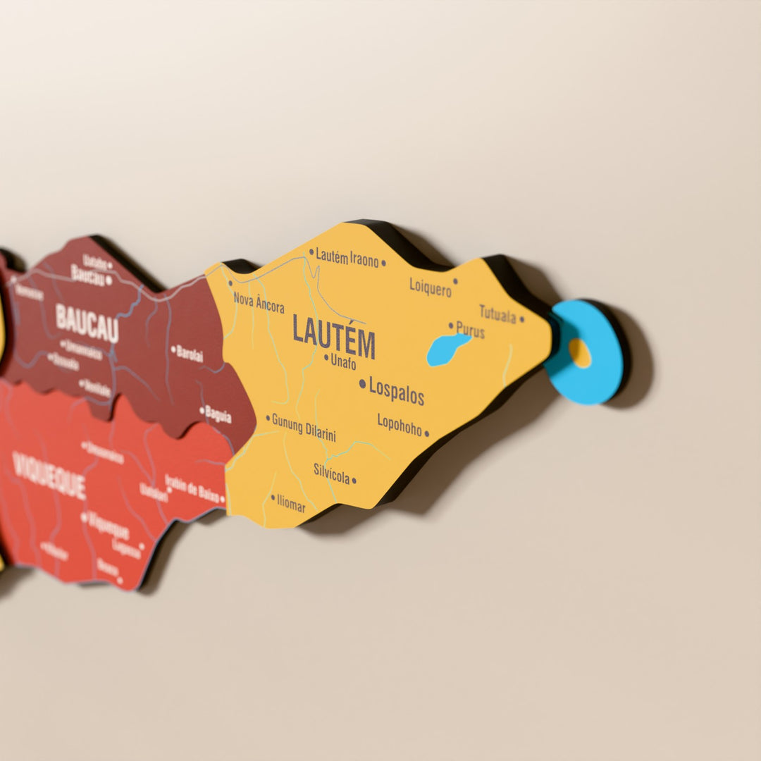 Close-up of the Flag colored East Timor wooden wall map with layered regions and printed names