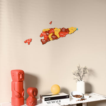 Flag colored East Timor wooden wall map on a beige wall above a console with figurines