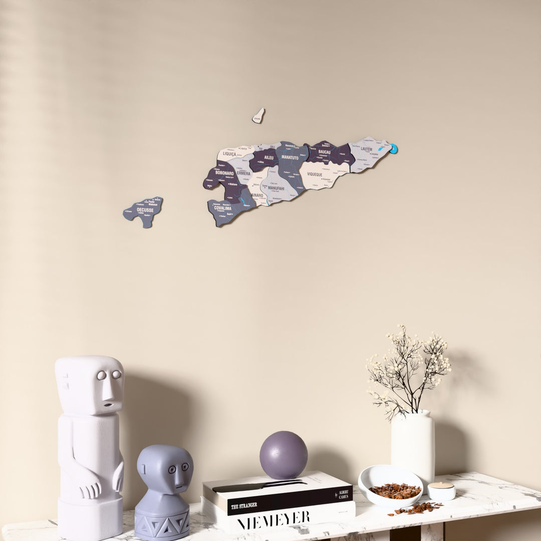 Nimbus East Timor wooden wall map on a beige wall above a console with figurines