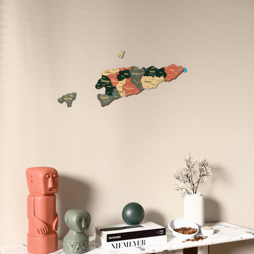 Sage East Timor wooden wall map on a beige wall above a console with figurines