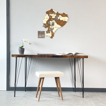 Wooden Ecuador map above a slim console desk with a white upholstered stool