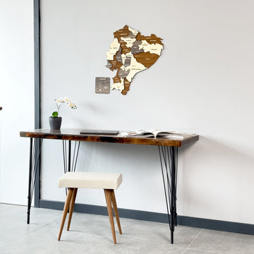 Ecuador wooden map high on the wall, wide view of a hairpin-leg desk and stool below