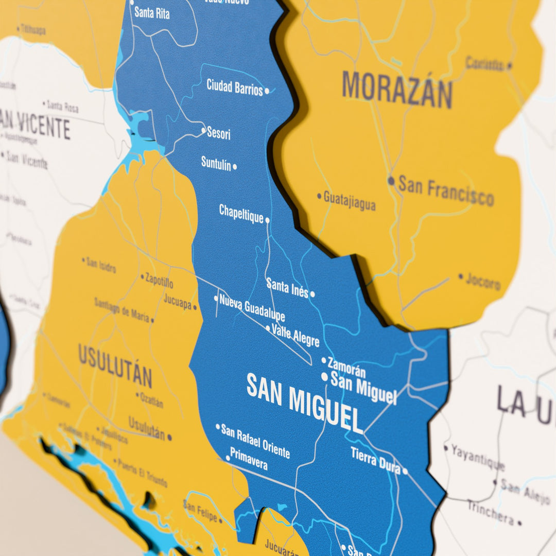 Close-up of the Flag colored El Salvador wooden wall map with layered regions and printed names