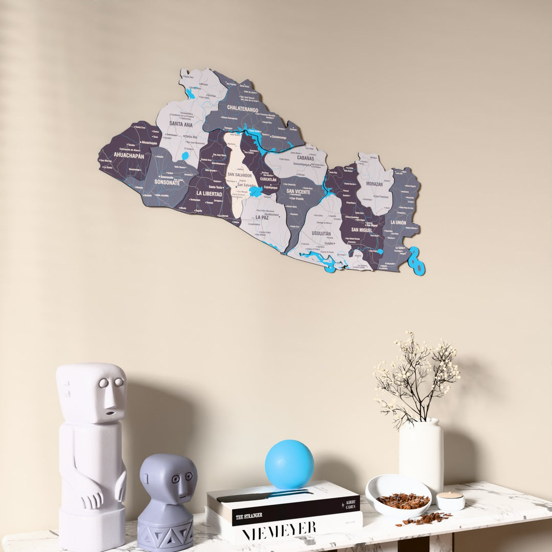 Nimbus El Salvador wooden wall map on a beige wall above a console with figurines