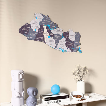 Nimbus El Salvador wooden wall map on a beige wall above a console with figurines