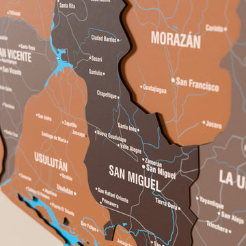 Close-up of the Soil El Salvador wooden wall map with layered regions and printed names