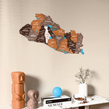 Soil El Salvador wooden wall map on a beige wall above a console with figurines