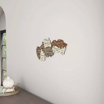 Slovakia wooden wall map beside a window arch, with a tray on the desk below