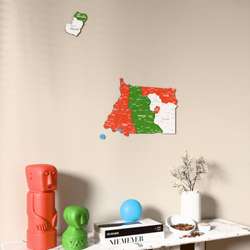 Flag colored Equatorial Guinea wooden wall map on a beige wall above a console with figurines
