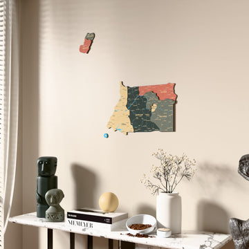 Sage Equatorial Guinea wooden wall map beside a sheer curtain, angled view