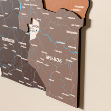 Close-up of the Soil Equatorial Guinea wooden wall map with layered regions and printed names