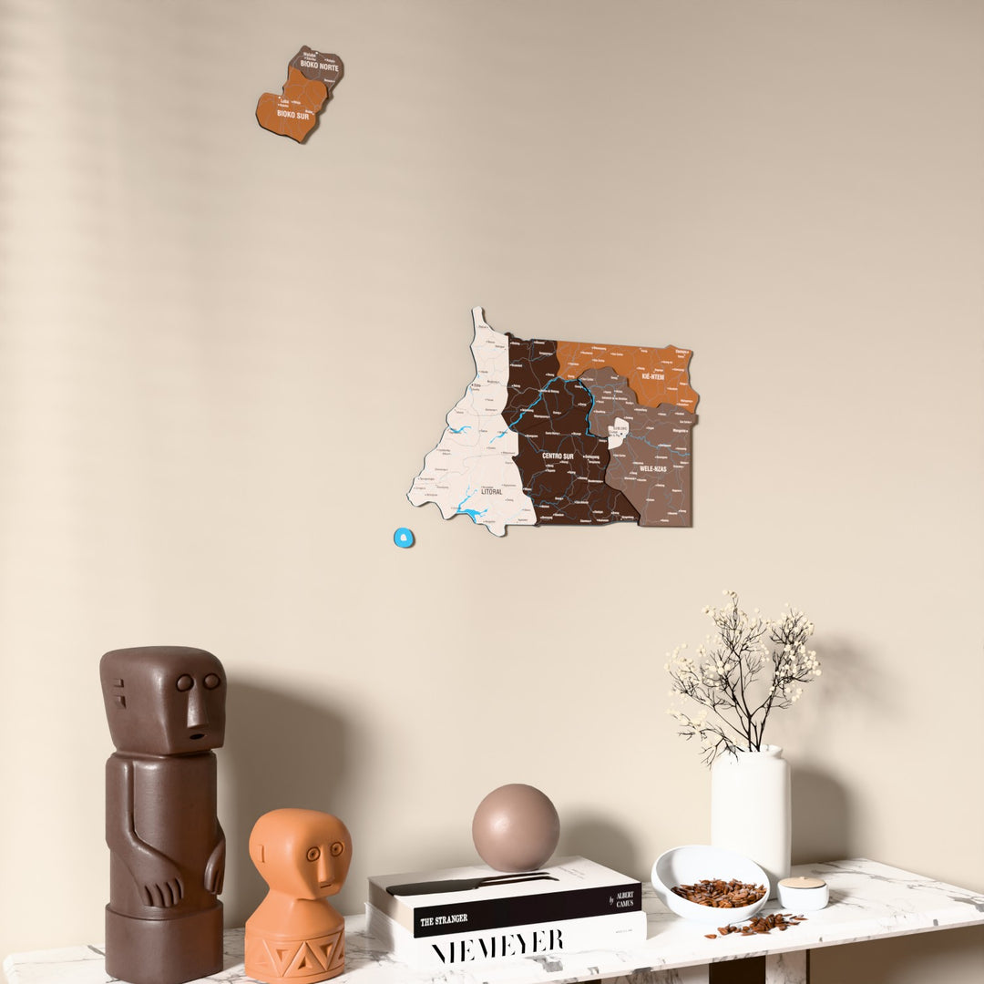 Soil Equatorial Guinea wooden wall map on a beige wall above a console with figurines