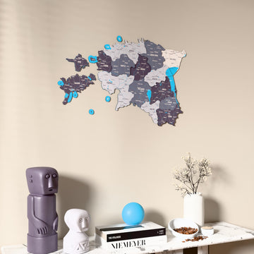 Nimbus Estonia wooden wall map on a beige wall above a console with figurines