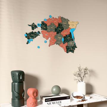 Sage Estonia wooden wall map on a beige wall above a console with figurines