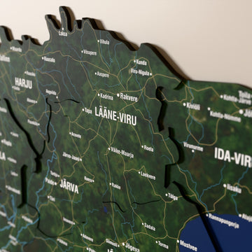 Close-up of the Satellite Estonia wooden wall map with layered regions and printed names