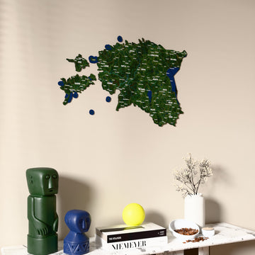 Satellite Estonia wooden wall map on a beige wall above a console with figurines
