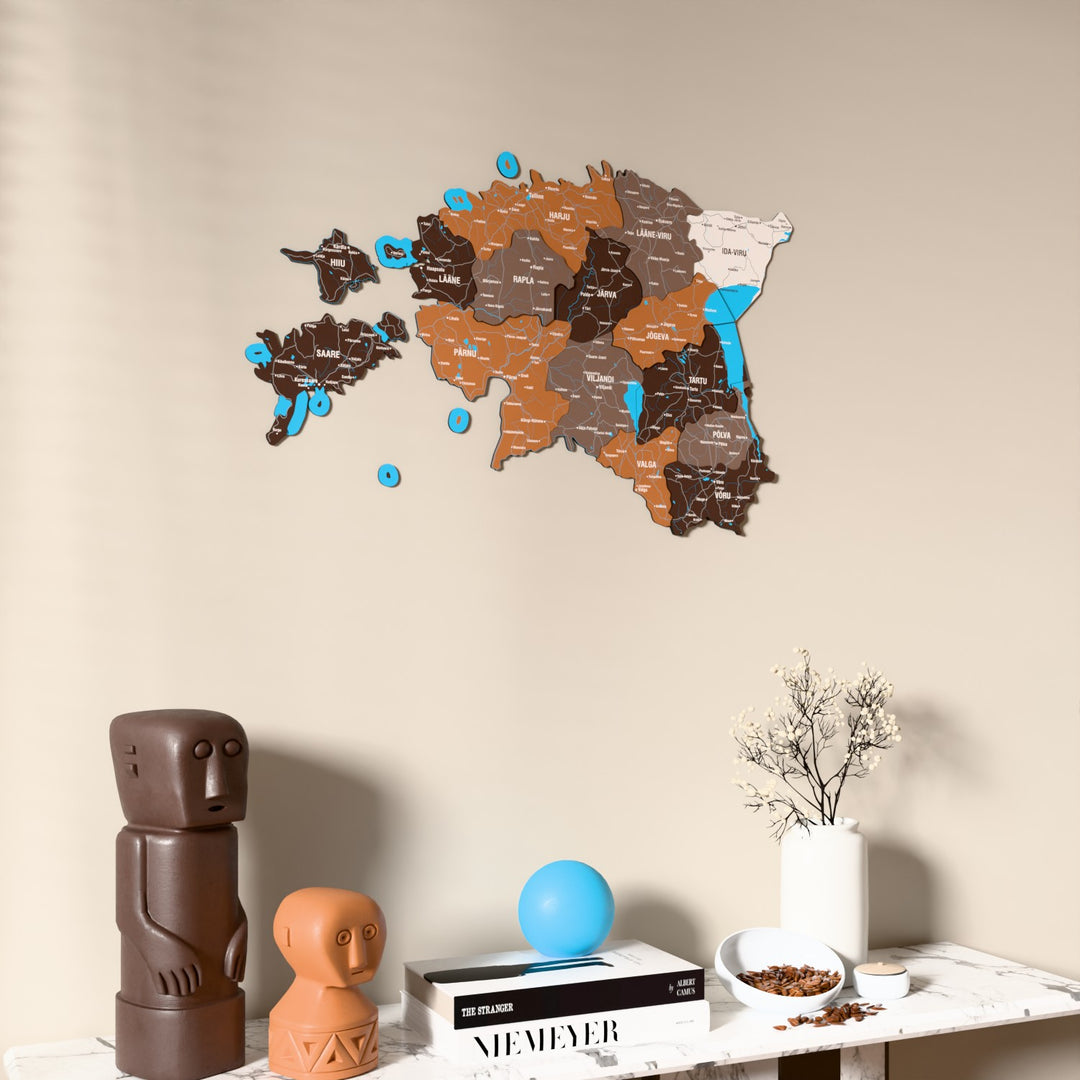 Soil Estonia wooden wall map on a beige wall above a console with figurines