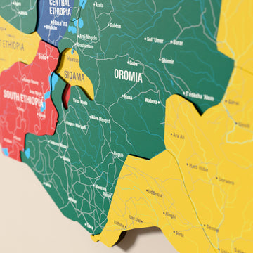 Close-up of the Flag colored Ethiopia wooden wall map with layered regions and printed names