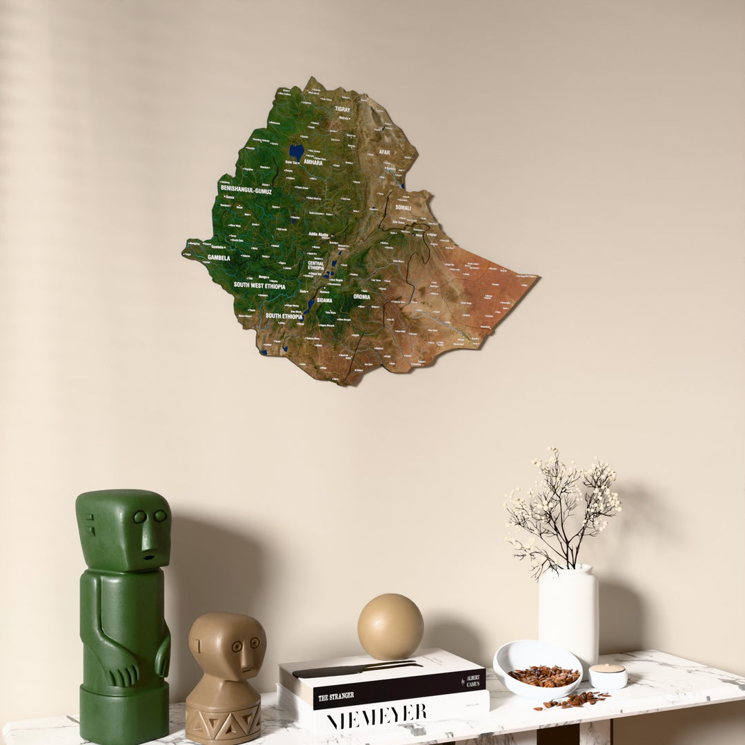 Satellite Ethiopia wooden wall map on a beige wall above a console with figurines