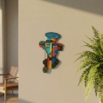 Fauvist portrait metal wall art on a sunlit wall next to a fern