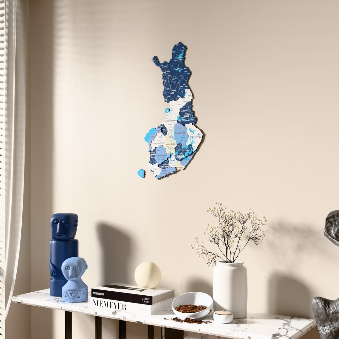 Flag colored Finland wooden wall map beside a sheer curtain, angled view