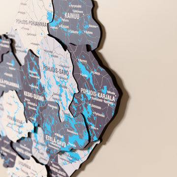 Close-up of the Nimbus Finland wooden wall map with layered regions and printed names