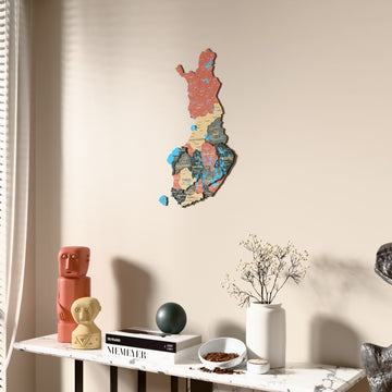 Sage Finland wooden wall map beside a sheer curtain, angled view
