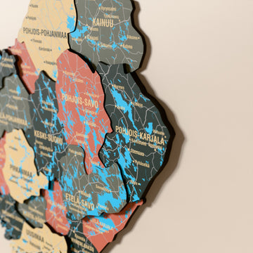 Close-up of the Sage Finland wooden wall map with layered regions and printed names