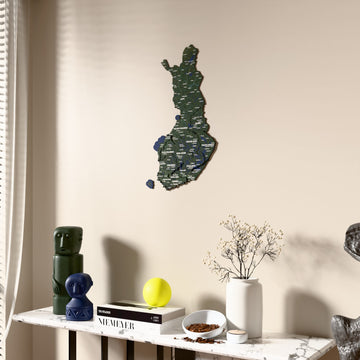 Satellite Finland wooden wall map beside a sheer curtain, angled view