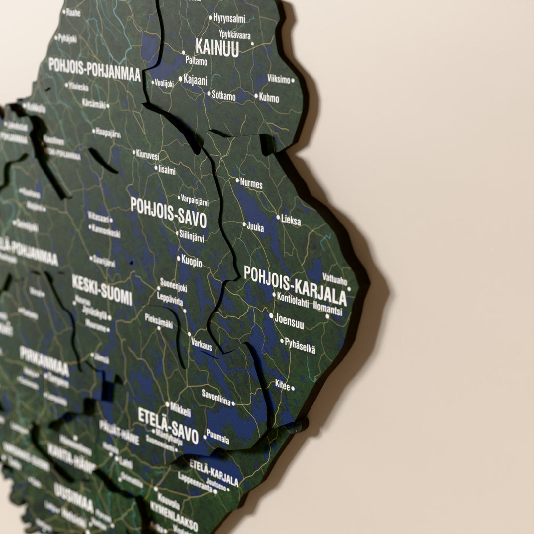 Close-up of the Satellite Finland wooden wall map with layered regions and printed names