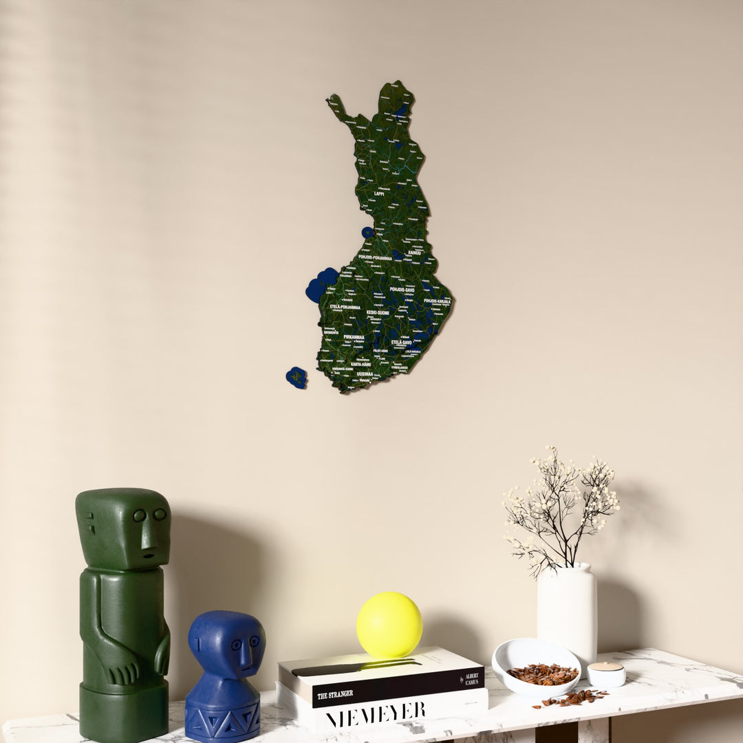 Satellite Finland wooden wall map on a beige wall above a console with figurines