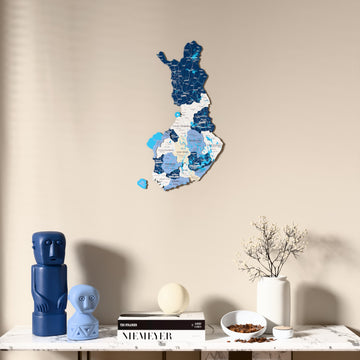 Flag colored Finland wooden wall map above a marble console, front view