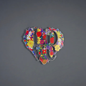 Floral LOVE heart metal art in the middle of a grey wall