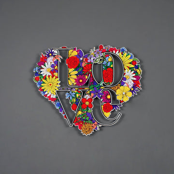 Floral LOVE heart metal wall art on a grey wall, medium distance