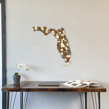Multicolor wooden Florida wall map, close view above the corner of a dark desk