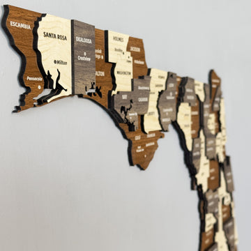 Angled close-up of the Florida panhandle on the wooden map with Santa Rosa, Walton and Washington counties