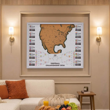 White framed 2026 World Cup cork map with group flags and bracket above a cream sectional sofa