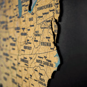 Blurred side-angle close-up of Pennsylvania, Virginia and North Carolina on the cork USA map