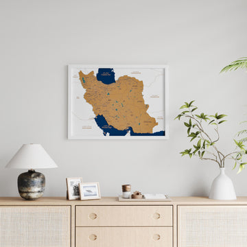White-framed Iran cork map, medium shot above a vase with branches