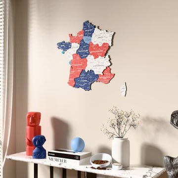 Flag colored France wooden wall map beside a sheer curtain, angled view