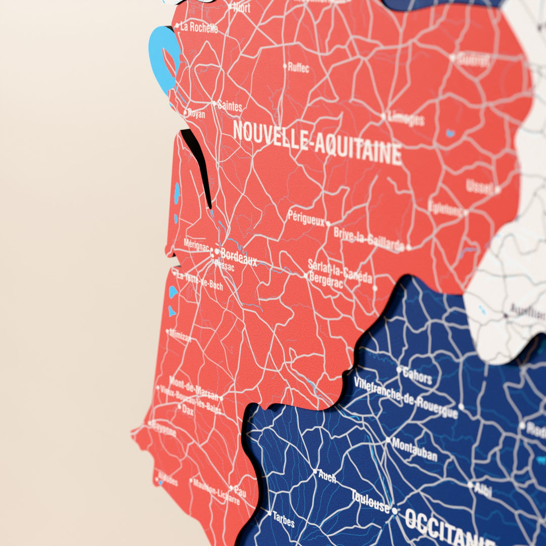 Close-up of the Flag colored France wooden wall map with layered regions and printed names
