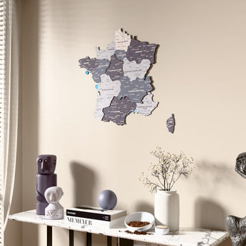 Nimbus France wooden wall map beside a sheer curtain, angled view